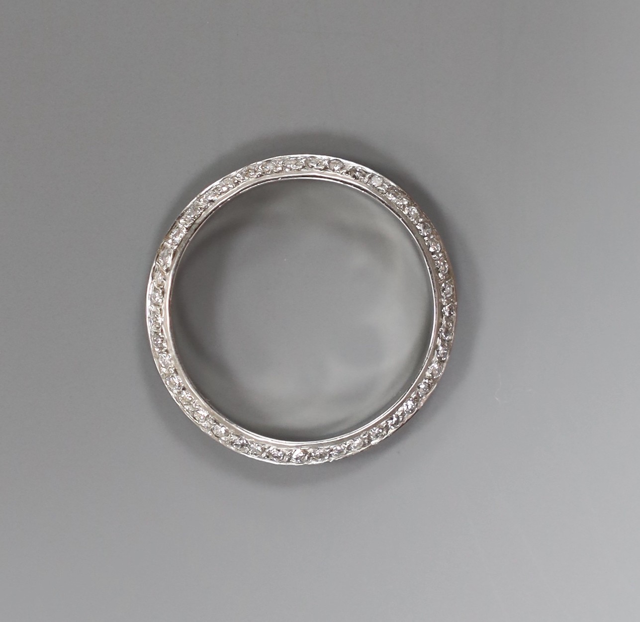 A modern white metal (tests as platinum) and two row diamond chip set full eternity ring, size L, gross weight 1.9 grams.